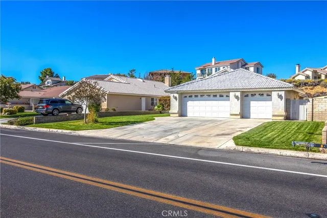 a front view of a house with a garden and yard