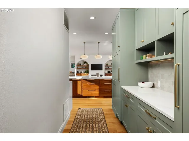 a kitchen with stainless steel appliances a sink stove and cabinets