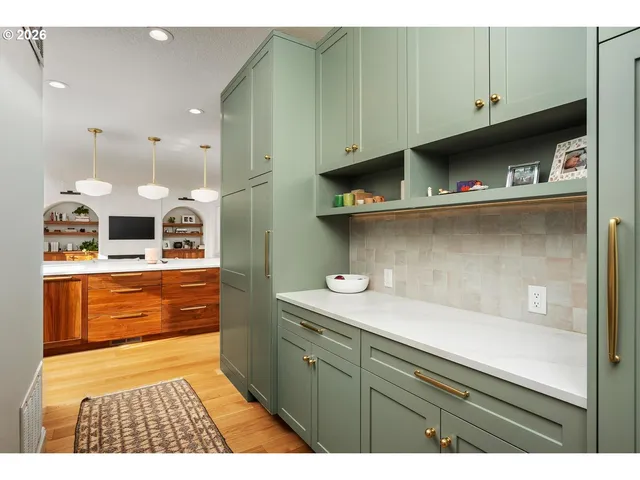 a kitchen with stainless steel appliances granite countertop a sink and cabinets