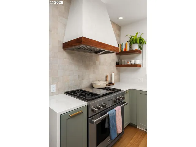 a kitchen with stainless steel appliances granite countertop a stove and a microwave