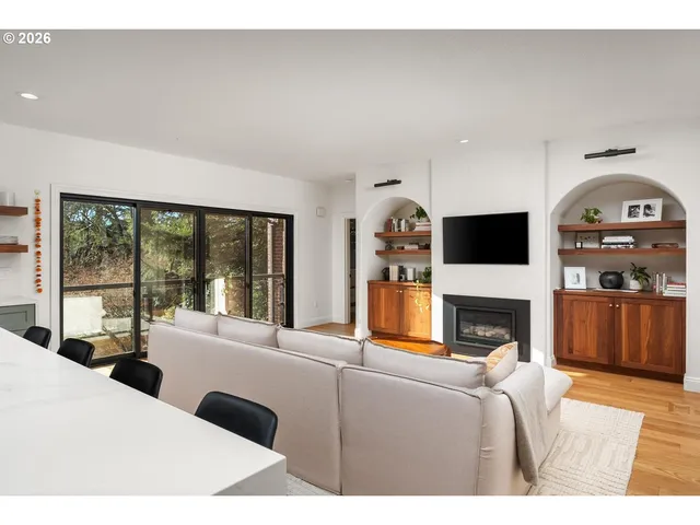 a living room with furniture a fireplace and a flat screen tv