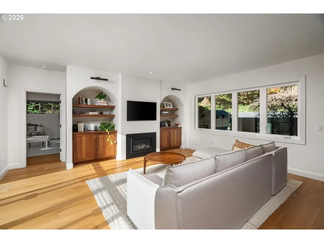 a living room with furniture a fireplace and a flat screen tv