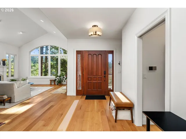 a spacious bedroom with a bed and wooden floor