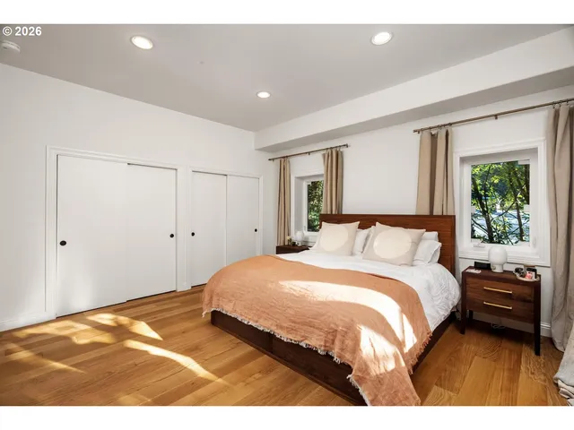 a bedroom with a bed and a large window