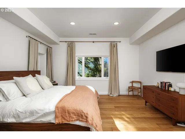 a bedroom with a bed and a flat screen tv