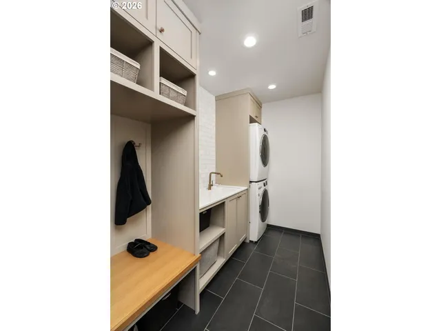 a bathroom with a double vanity sink toilet and tub
