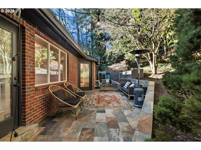 a backyard of a house with table and chairs