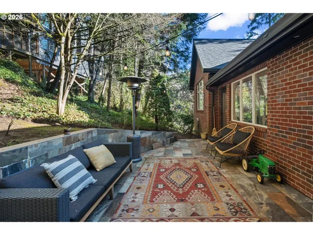 a view of a couches in patio of back yard