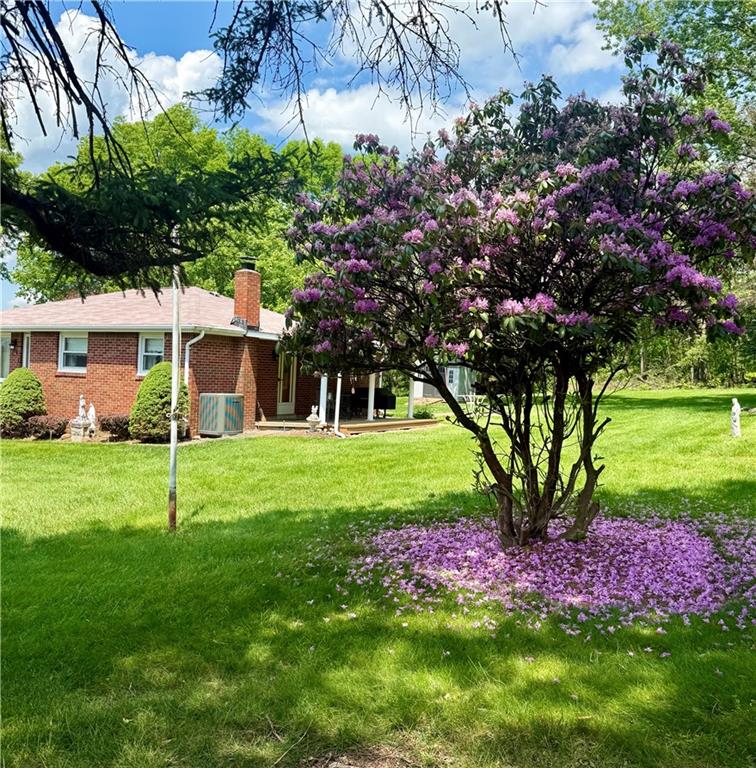 151 Huntingdon Road Wyano, PA 15695 - Photo 4 of 36 a view of a house with a yard and a garden