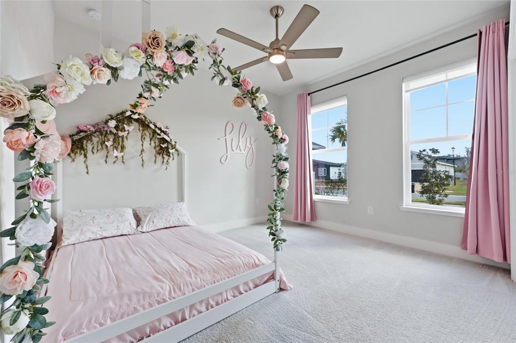 534 Southwest 145th Drive Newberry, FL 32669 - Photo 15 of 38 a bedroom with a large bed and a chandelier