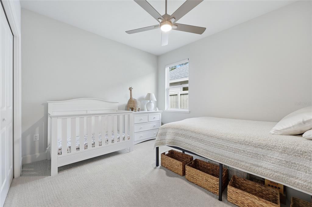 534 Southwest 145th Drive Newberry, FL 32669 - Photo 18 of 38 a bedroom with a bed and a chandelier