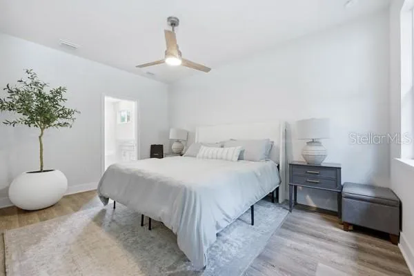 a bedroom with a bed and a chandelier