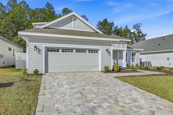534 Southwest 145th Drive Newberry, FL 32669 - Photo 35 of 38 a front view of a house with a yard and garage