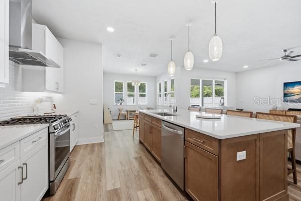 534 Southwest 145th Drive Newberry, FL 32669 - Photo 6 of 38 a kitchen with kitchen island granite countertop a sink a stove top oven a counter space and cabinets