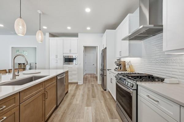 534 Southwest 145th Drive Newberry, FL 32669 - Photo 7 of 38 a kitchen with kitchen island granite countertop stainless steel appliances a sink a stove and cabinets
