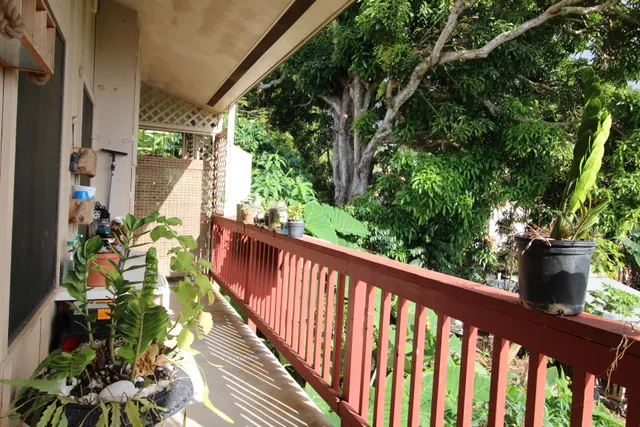 a view of a balcony with wooden floor