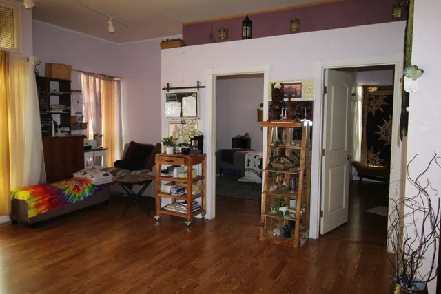 a living room with furniture and wooden floor
