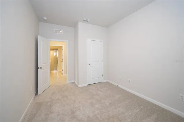 a view of an empty room and closet area