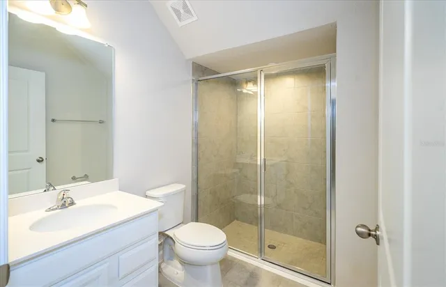 a bathroom with a shower and a sink