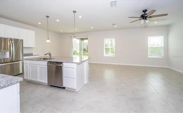 a kitchen with refrigerator and window
