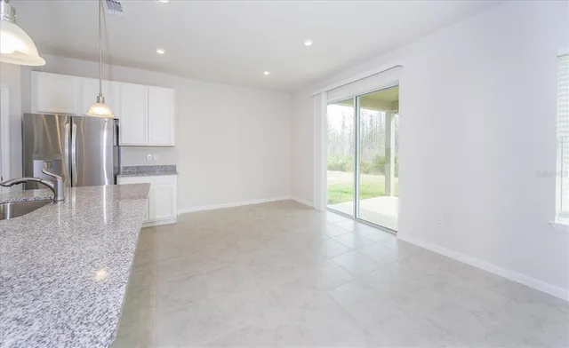 a view of a kitchen with a sink and a refrigerator