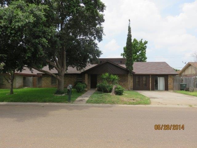 5506 Cypress Drive Laredo, TX 78041 - Photo 1 of 6 a front view of a house with a garden and trees