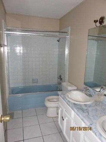 5506 Cypress Drive Laredo, TX 78041 - Photo 5 of 6 a bathroom with a granite countertop sink toilet and shower