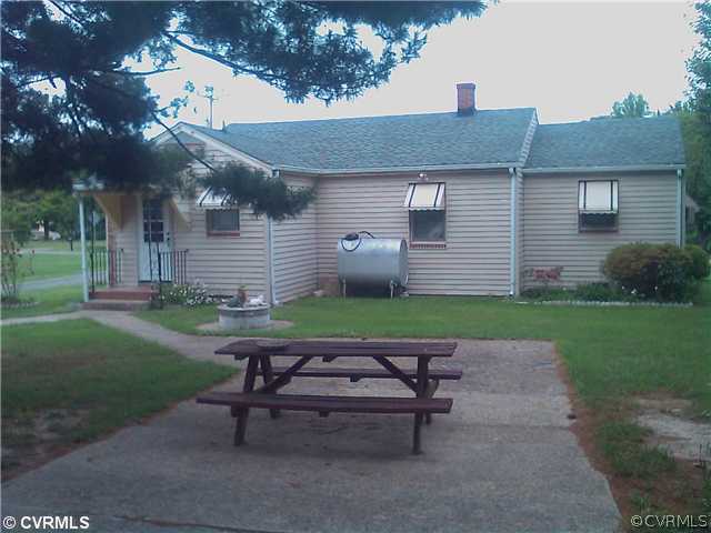 6325 Pole Green Road Mechanicsville, VA 23111 - Photo 2 of 3 a backyard of a house with table and chairs