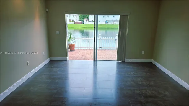 a view of a room with wooden floor and a window