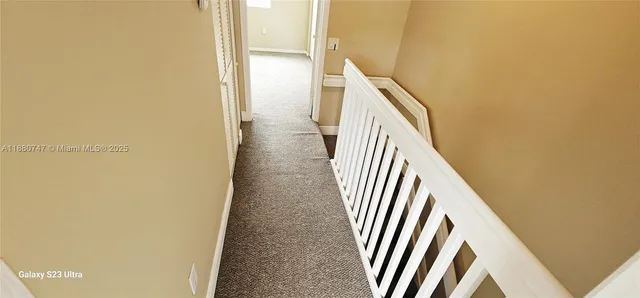 a view of a hallway with front door