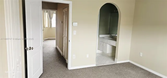 a view of a bathroom from a hallway