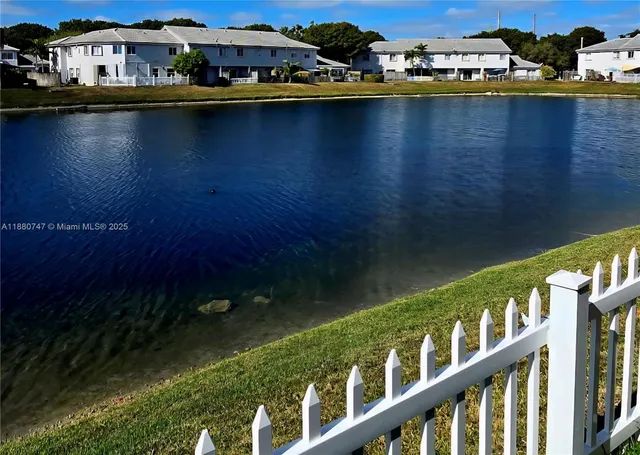 a view of a lake with wooden floor and city view
