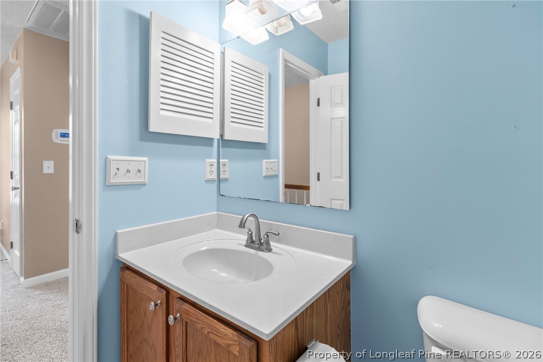 28 Coyt Circle Spring Lake, NC 28390 - Photo 29 of 41 a bathroom with a sink toilet and mirror