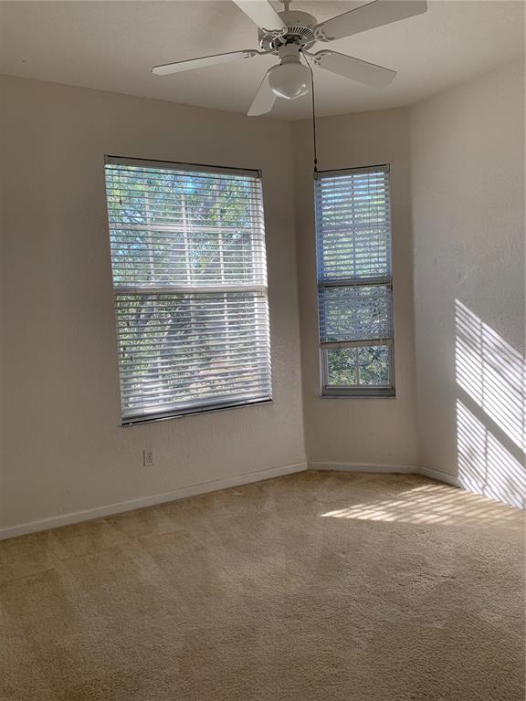 13500 Turtle Marsh Loop, Unit 837 Orlando, FL 32837 - Photo 23 of 30 an empty room with windows and chandelier fan