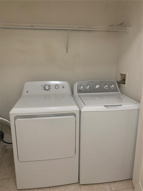 13500 Turtle Marsh Loop, Unit 837 Orlando, FL 32837 - Photo 4 of 30 a utility room with dryer and washer