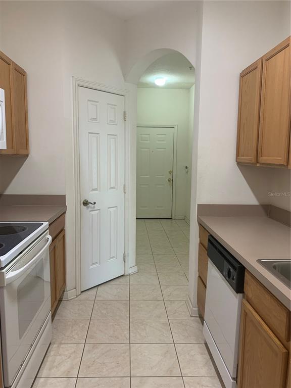 13500 Turtle Marsh Loop, Unit 837 Orlando, FL 32837 - Photo 6 of 30 a view of a kitchen with a sink stove and cabinets