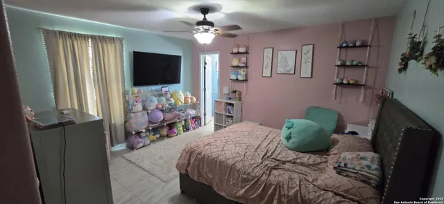 a bedroom with a bed and a flat tv screen