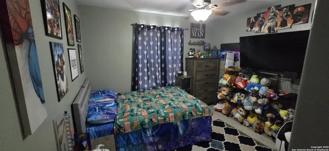 a bedroom with a bed closet and a flat tv screen