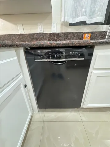 a kitchen with granite countertop a stove and a refrigerator