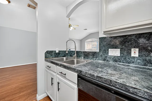 a large kitchen with stainless steel appliances granite countertop a stove and a sink