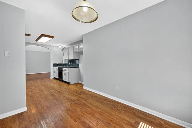a view of a living room with wooden floor