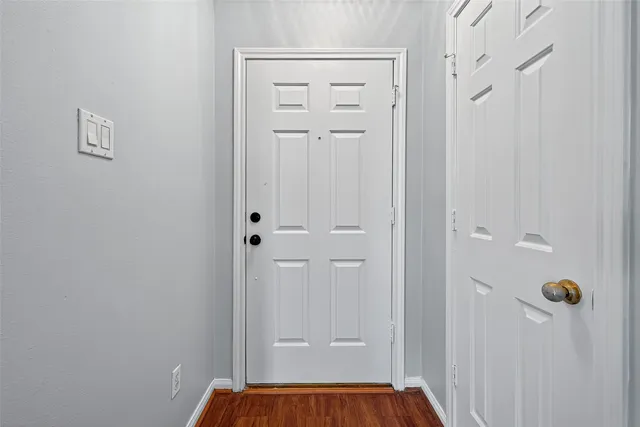 a view of a room with wooden floor and a fireplace