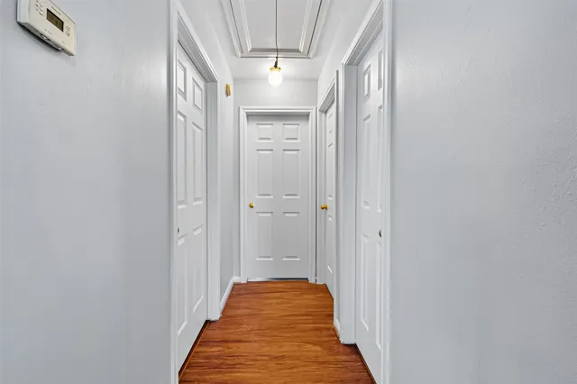 a view of an empty room with wooden floor