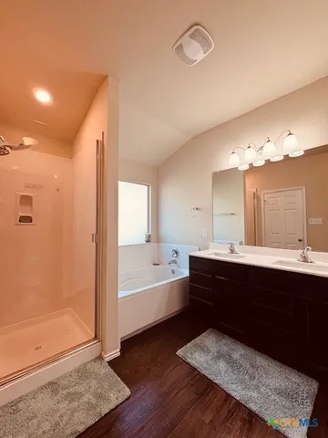 a spacious bathroom with a bathtub and a sink