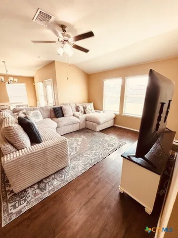 a living room with furniture rug and a window