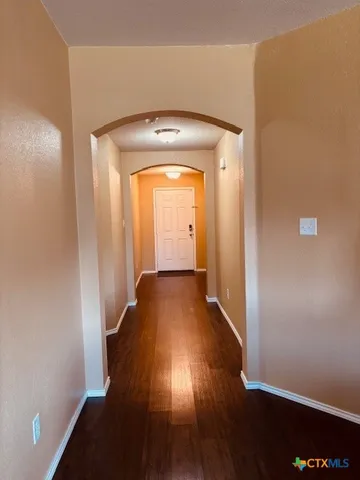 a view of a room with wooden floor and a window