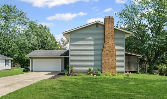 a front view of house with yard and green space