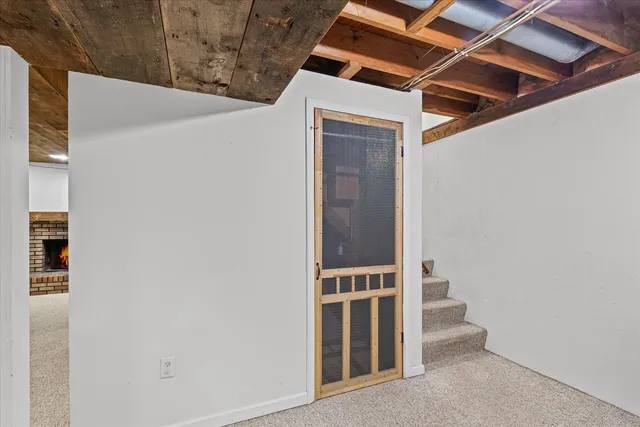 a view of livingroom with an empty space and fireplace