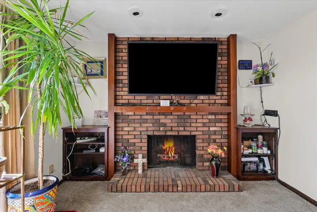 a living room with a fireplace and a flat screen tv