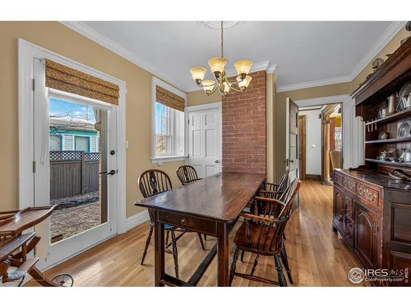 a kitchen with stainless steel appliances granite countertop a stove a sink dishwasher and a dining table with wooden cabinet